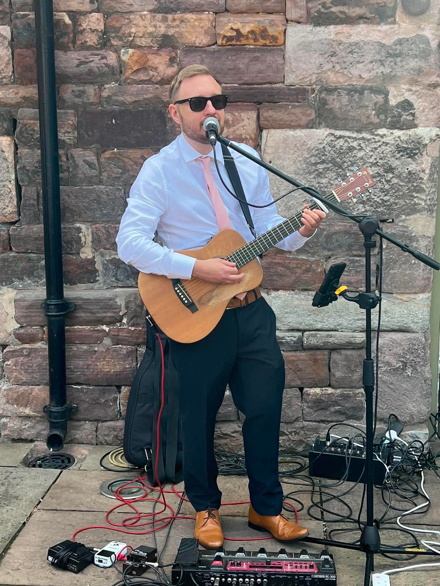 Ben singing and playing guitar outdoors