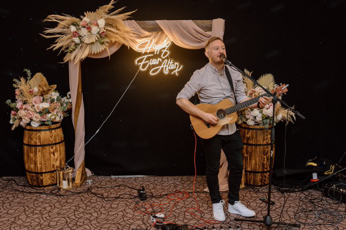 Ben performing on stage at a celebration